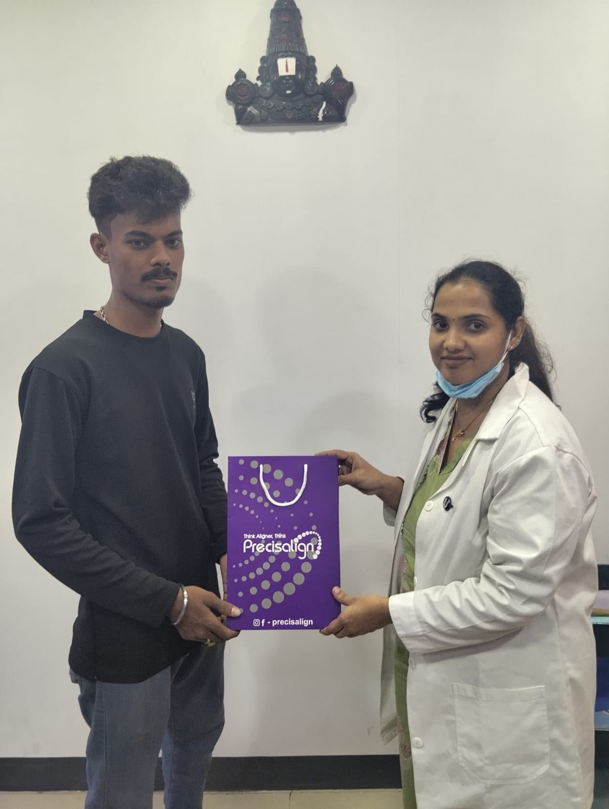 Male patient receiving Precisalign aligner kit bag from Glodent orthodontist